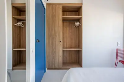 a bedroom with wooden cabinets and a blue door at Kallithea Apartments by Olala Homes in Athens