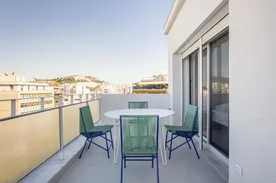 a balcony with a table and chairs on it at Kallithea Apartments by Olala Homes in Athens