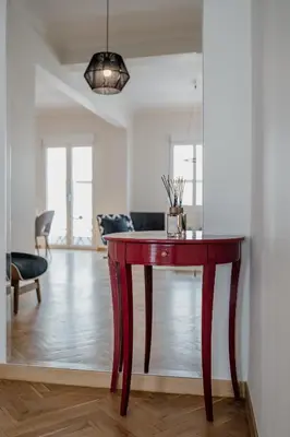 a red table in a room with a living room at Bella in Athens