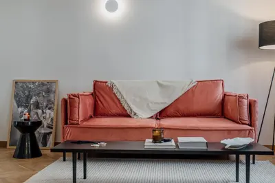 a red couch in a living room with a coffee table at Bella in Athens