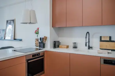 a kitchen with orange cabinets and a sink at Bella in Athens