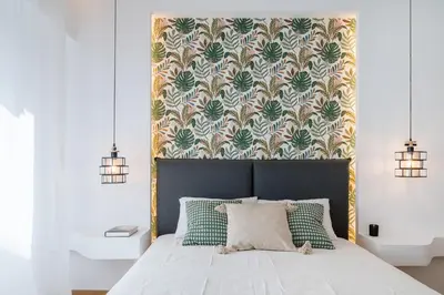 a bedroom with a bed with a floral wallpaper at Zelda in Athens