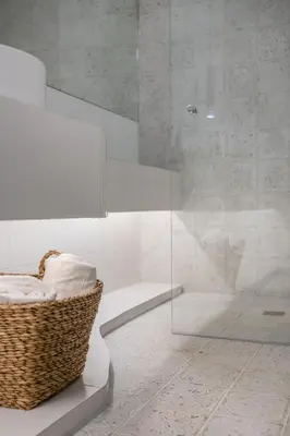 a bathroom with a glass shower with a basket at Zelda in Athens