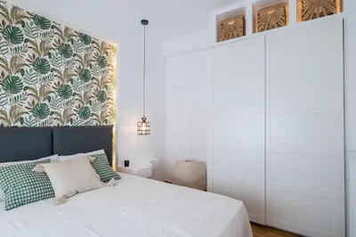 a bedroom with a white bed with a headboard at Zelda in Athens