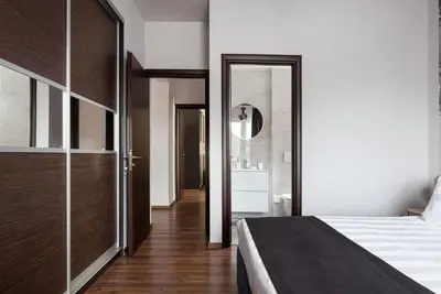 a bedroom with a bed and a bathroom at Glyfada Premium Residence in Athens