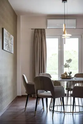 a dining room with a table and chairs and a window at Glyfada Premium Residence in Athens