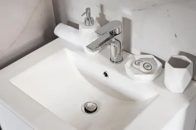 a white sink in a bathroom with a toilet at Glyfada Premium Residence in Athens