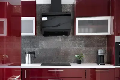 a kitchen with red cabinets and a sink with a coffee maker at Glyfada Premium Residence in Athens