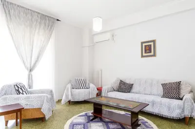 a living room with two couches and a coffee table at Sunny Dream House in Piraeus