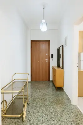 a hospital hallway with a cart in front of a door at Sunny Dream House in Piraeus