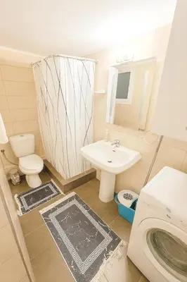 a small bathroom with a sink and a toilet at Sunny Dream House in Piraeus