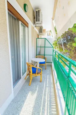 a patio with two chairs and a table on a balcony at Sunny Dream House in Piraeus