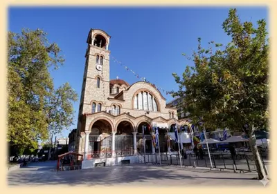a building with a tower with a clock on it at Sunny Dream House in Piraeus