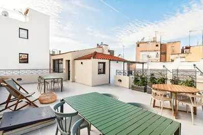 a patio with tables and chairs on a balcony at Limehome Athens Solonos City Center in Athens
