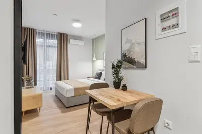 a hotel room with a bed and a table and a bed at Limehome Athens Solonos City Center in Athens