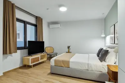 a bedroom with a bed and a flat screen tv at Limehome Athens Solonos City Center in Athens