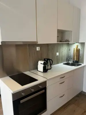 a kitchen with white cabinets and a sink at Athena 1 in Athens