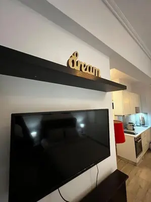 a flat screen tv sitting on top of a wall at Athena 1 in Athens