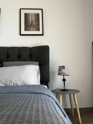 a bedroom with a bed and a table with a lamp at Athena 1 in Athens
