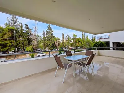a dining room with a table and chairs on a balcony at Kapodistriou by Verde Apartments in Athens