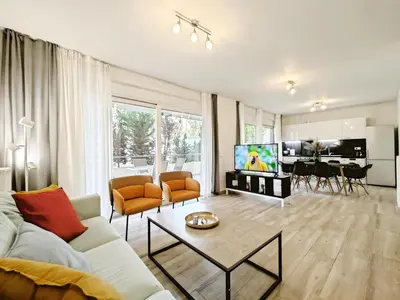 a living room with a couch and a tv at Kapodistriou by Verde Apartments in Athens