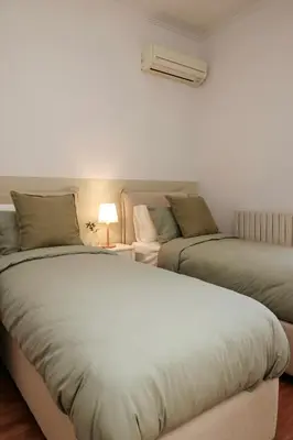 two beds sitting next to each other in a room at MINT - Modern apartment in the heart of Chalandri in Athens