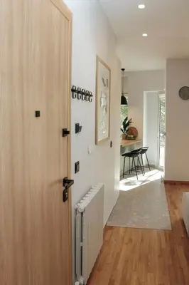 a hallway with a door leading to a dining room at MINT - Modern apartment in the heart of Chalandri in Athens