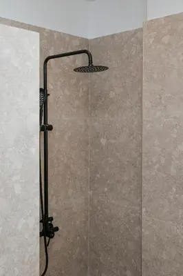 a shower with a shower head in a bathroom at MINT - Modern apartment in the heart of Chalandri in Athens