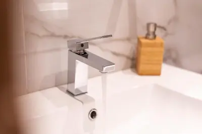 a bathroom sink with a faucet and a wooden block at Mini Suites Near Athen's Airport Free Shuttle From and to Athen's Airport in Spáta