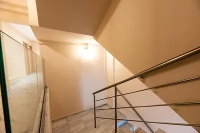 a staircase in a house with a glass railing at Mini Suites Near Athen's Airport Free Shuttle From and to Athen's Airport in Spáta