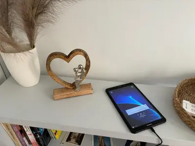 a small statue of a man next to a heart on a table at Ruby’s House in Athens