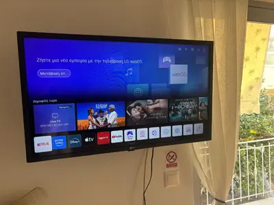 a flat screen tv hanging on a wall at Ruby’s House in Athens