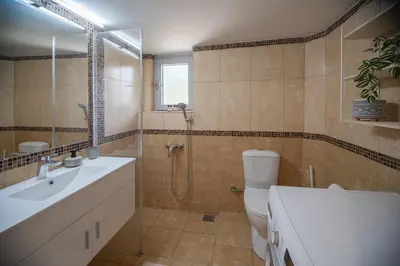 a bathroom with a toilet and a shower and a sink at Ruby’s House in Athens