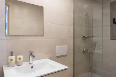 a bathroom with a sink and a shower at Voula's Secret Garden Studio in Athens