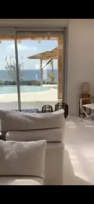 two beds in a room with a view of the ocean at Seafront Athens Riviera Lagonisi Villa in Lagonissi