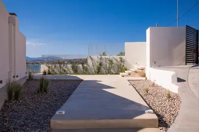 a walkway in front of a white building at Seafront Athens Riviera Lagonisi Villa in Lagonissi