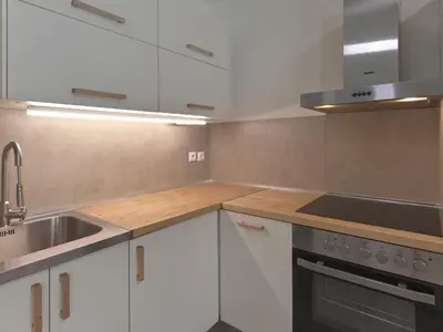 a kitchen with white cabinets and a sink at Prime Location in Kolonaki A Luxurious 1BR Haven in Athens