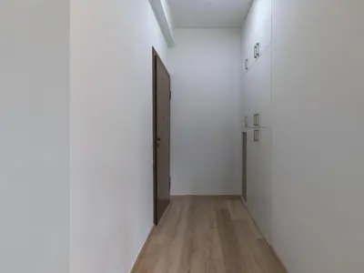 a hallway with a black door and a wooden floor at Prime Location in Kolonaki A Luxurious 1BR Haven in Athens