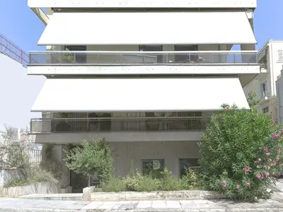 a building with a white awning on the side of it at Prime Location in Kolonaki A Luxurious 1BR Haven in Athens