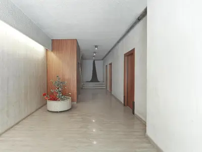 an empty hallway with a potted plant in the middle at Prime Location in Kolonaki A Luxurious 1BR Haven in Athens