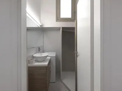 a white bathroom with a sink and a mirror at Prime Location in Kolonaki A Luxurious 1BR Haven in Athens