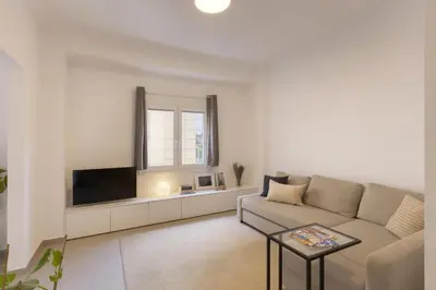 a living room with a couch and a tv at Kerameikou25 large in Athens
