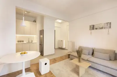 a living room with a couch and a table at Kerameikou25 small in Athens