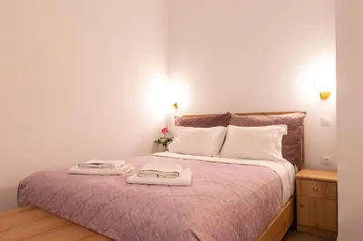 a bedroom with a bed with two towels on it at Harmony - Brand New Airport Apt. in Spáta