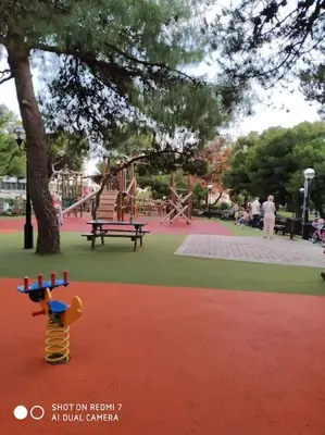 a park with a playground with a slide and a monkey toy at Quiet Family apartment with Garden and Balconies in Athens