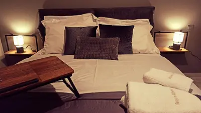 a bedroom with a large bed with two lamps at Stay in Athens - muses in Athens
