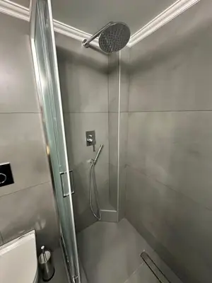 a shower with a glass door in a bathroom at Coastal Harmony Alimos in Athens