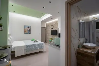 a bedroom with a bed and a bathroom with a sink at The Mint - Stylish Studio in Egaleo-Athens in Athens