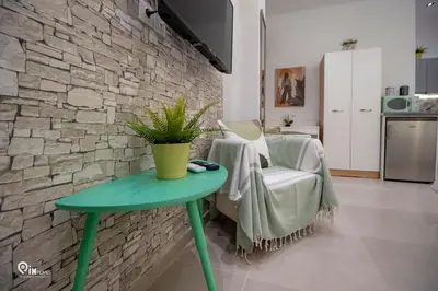 a green table and a chair in a kitchen at The Mint - Stylish Studio in Egaleo-Athens in Athens
