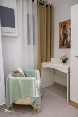 a bathroom with a sink and a chair and a table at The Mint - Stylish Studio in Egaleo-Athens in Athens
